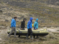 Giff, Simon, Darren, and Sarah carry an inflatable boat to the shore of a lake where they hope to obtain a sediment core. Photo by Matthew Kennedy of Earth Vision Trust.
