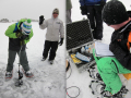 Left: Students use an ice auger on frozen Gold Lake. Taking turns with the auger is one way to stay warm on the ice! Right: The Hydrolab allows readout of barometric pressure, depth, water temperature, pH, specific conductance, and dissolved oxygen.