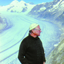 Above a tongue of Grossaletschgletscher in Switzerland, Mark Meier in a national Georgian cap he brought at a symposium that just finished in Tbilisi. Photo by Vladimir Kotlyakov, 1978.