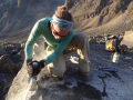 Sarah Crump samples a glacier moraine boulder for cosmogenic radionuclide dating. Photo by Kurt Refsnider.