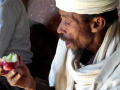 Rev Kahsay tastes an apple for the first time. Photo by Tsegay Wolde-Georgis, February 2011.